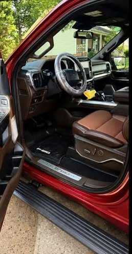 After: clean Ford F-150 King Ranch driver floor, leather seat, door sill and step plate following a Gleam Team mobile interior detail in the customer driveway in Charlotte NC