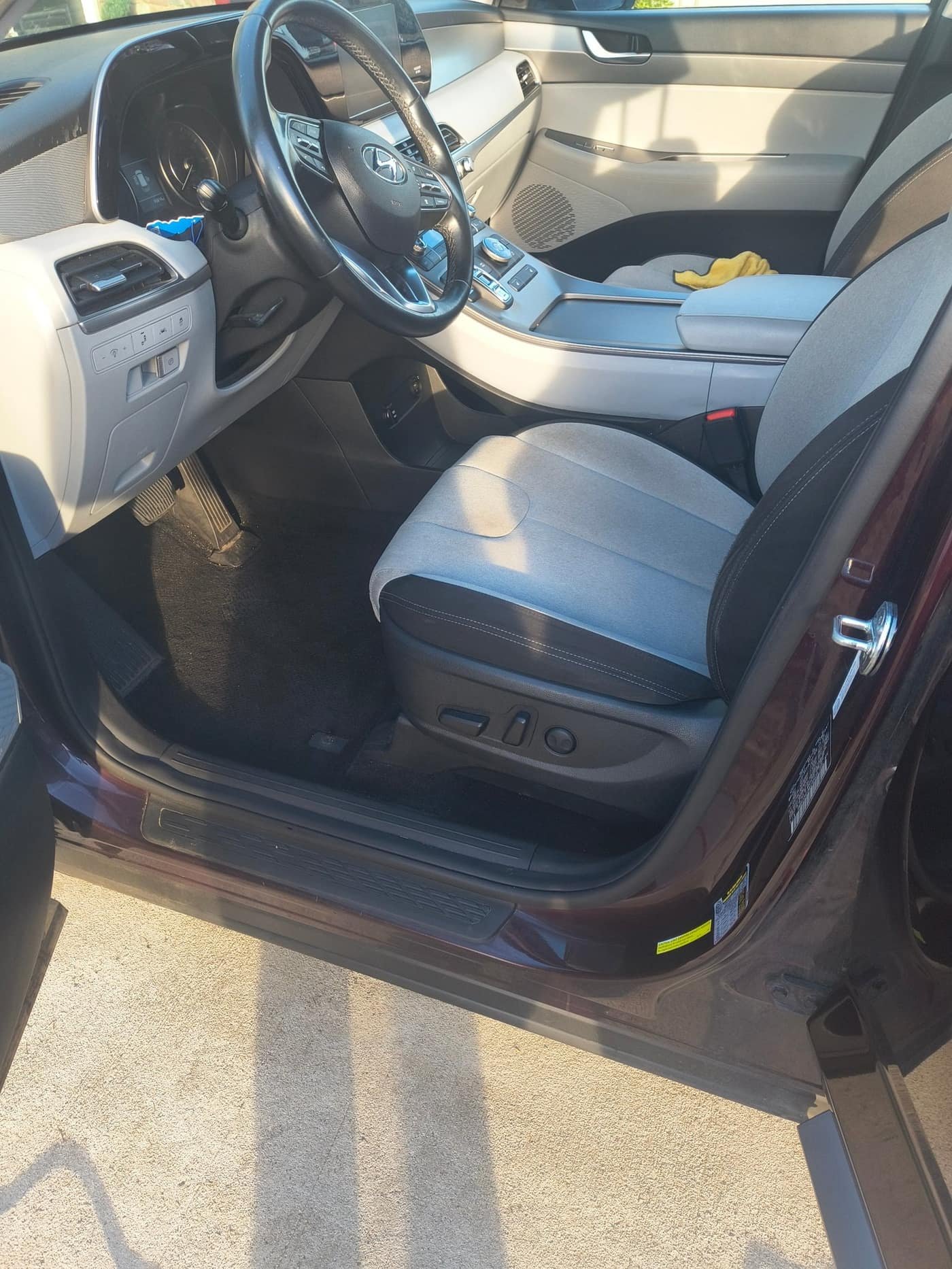 After: clean Hyundai SUV driver seat and carpet viewed from the open door after Gleam Team interior detail in Charlotte NC