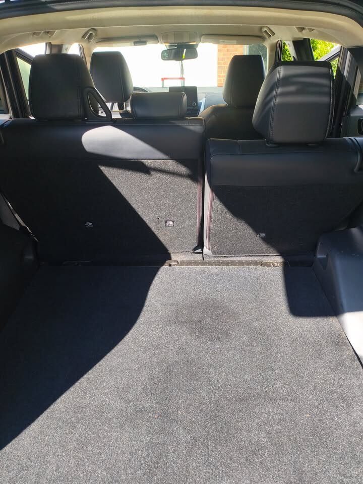 After: clean Mitsubishi SUV cargo area with rear seats folded following a Gleam Team interior detail in Charlotte and Raleigh NC